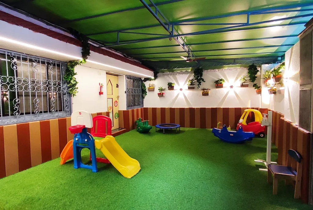 Eager Beaver creche play area with slide and soft turf
